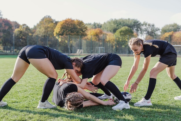 Free Photo athletic young girls playing rugby