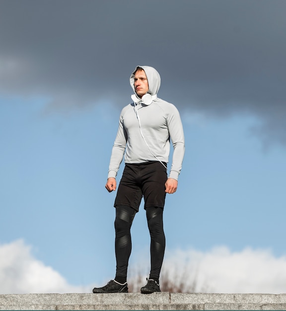 Athletic young man posing fashion outside