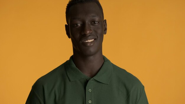 Attractive African American man dressed in casual wear looking confident on camera over colorful background