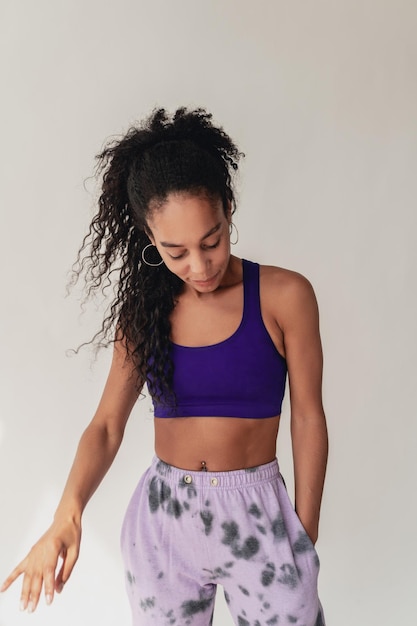 Attractive black african american woman posing in stylish hipster outfit on white background