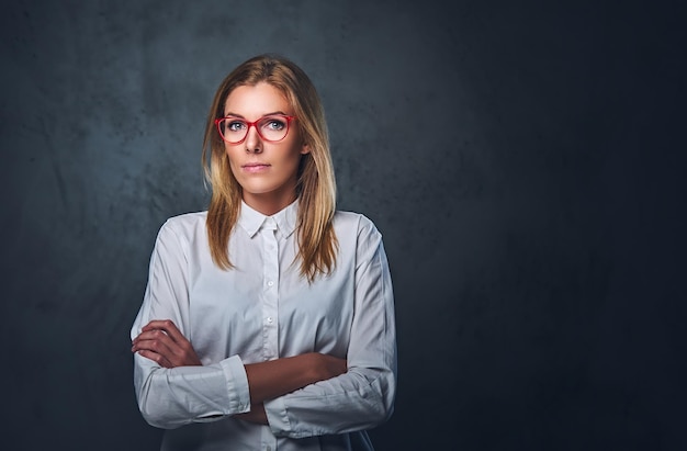 Free Photo attractive blond business woman in a white shirt, eyeglasses and crossed arms over grey background.