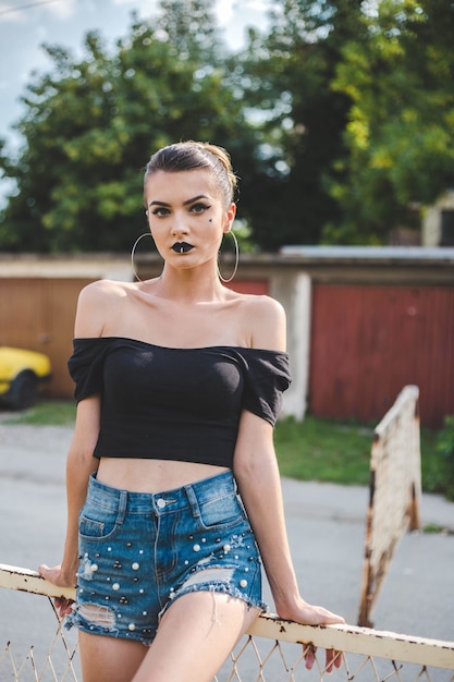 Free photo attractive bosnian caucasian woman wearing a black shirt looking at the camera with a serious face