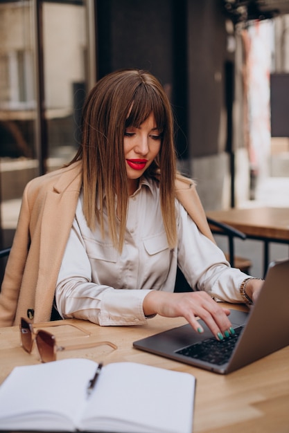 Attractive business woman working on computer in a cafe