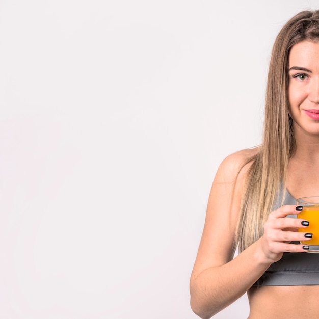 Free photo attractive cheerful woman with glass of juice