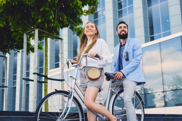 Attractive couple on a date after bicycle ride in a city.