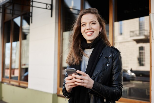 attractive female woman in trendy clothes walking along city