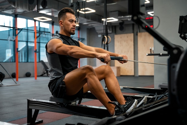 Attractive fit man working out at the gym