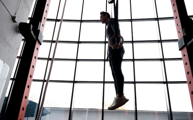 Free photo attractive fit man working out indoors at the gym