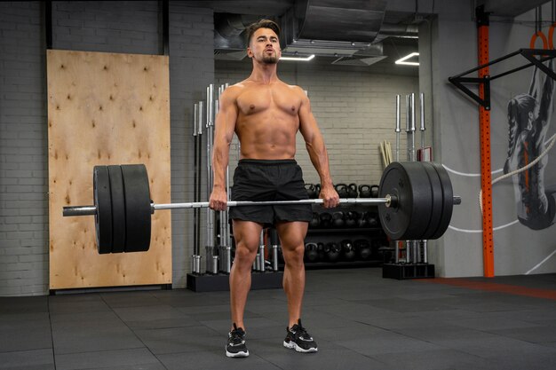 Attractive fit man working out indoors with weights