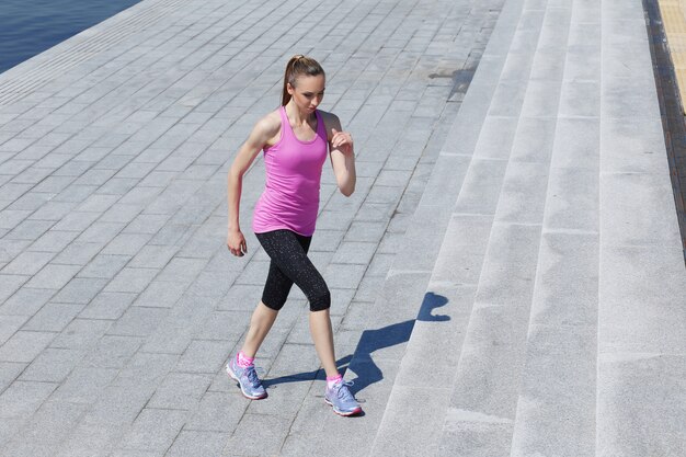 Attractive girl running on the street