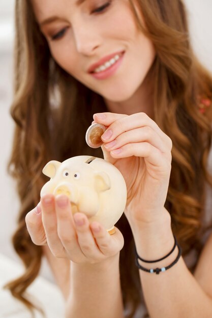 Attractive girl with moneybox