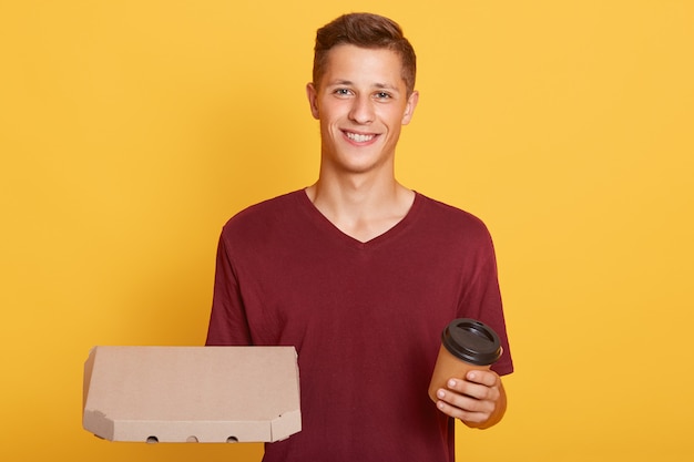 Free Photo attractive guy with take away coffee and carton box with pizza