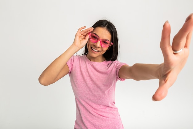 Attractive happy funny emotional woman in pink t-shirt isolated arms forward