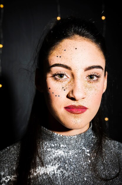 Attractive happy woman in silver dress with makeup