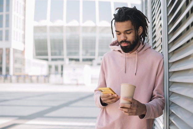 Attractive man looking on phone front view