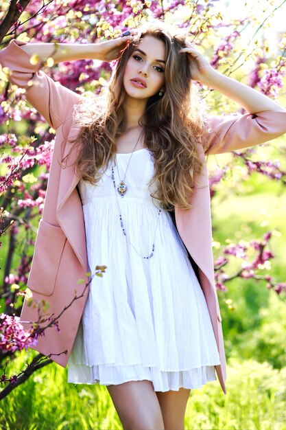 Attractive pretty young woman in light white dress