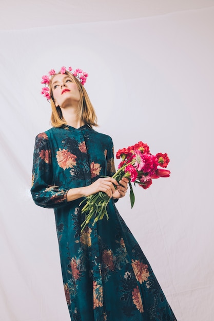 Free Photo attractive sensual woman with wreath on head and bouquet of flowers