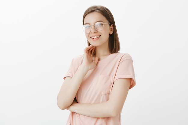 Attractive smiling woman in glasses looking dreamy 