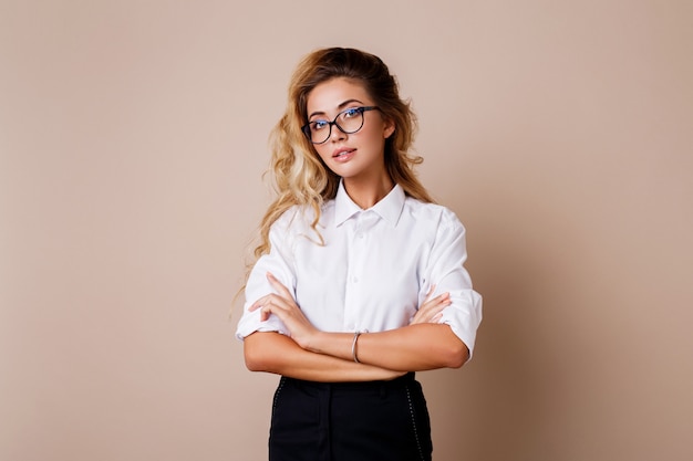 Free Photo attractive successful business woman with candid smile looking. teacher or employe. beige wall.