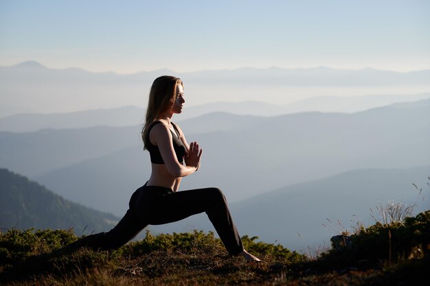 Attractive woman doing exercises on nature