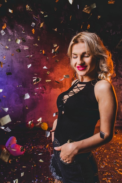 Attractive woman in falling confetti