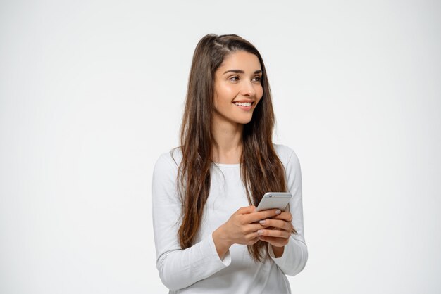 Attractive woman holding mobile phone, smiling