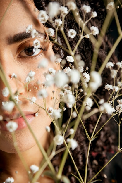 Free photo attractive woman looking through twigs