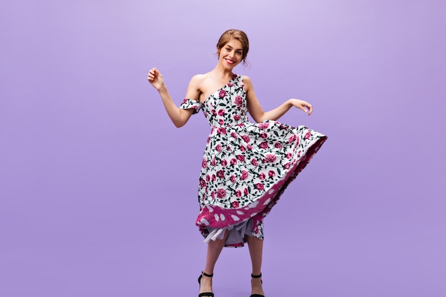 Attractive woman in midi dress dancing on isolated background. Attractive woman in midi dress dancing on isolated background.