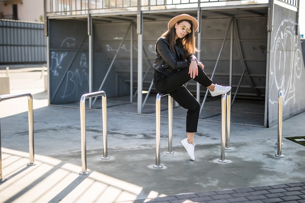 Free Photo attractive woman with gold hair posing at the skatepark in the city centre