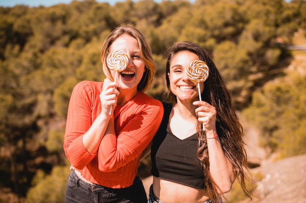 Free Photo attractive women with lollipops