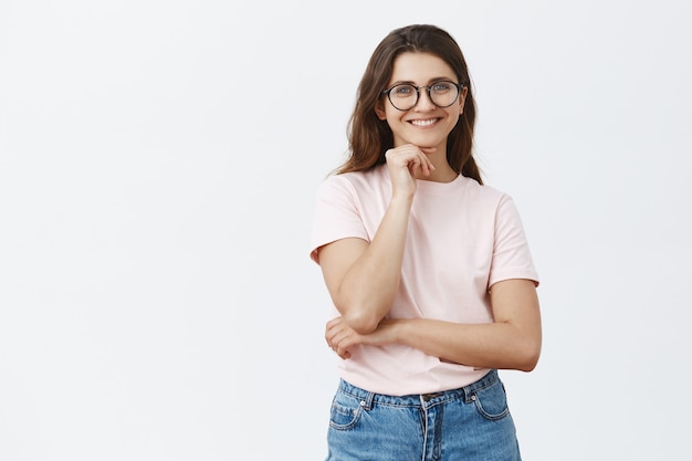 Attractive young brunette with glasses posing