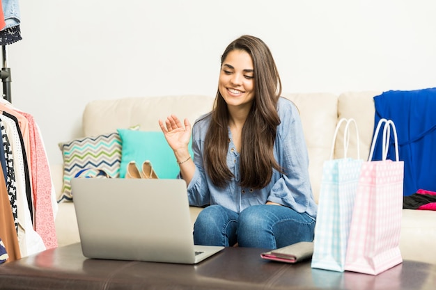 Attractive young female fashion blogger saying goodbye to her online audience during a broadcast