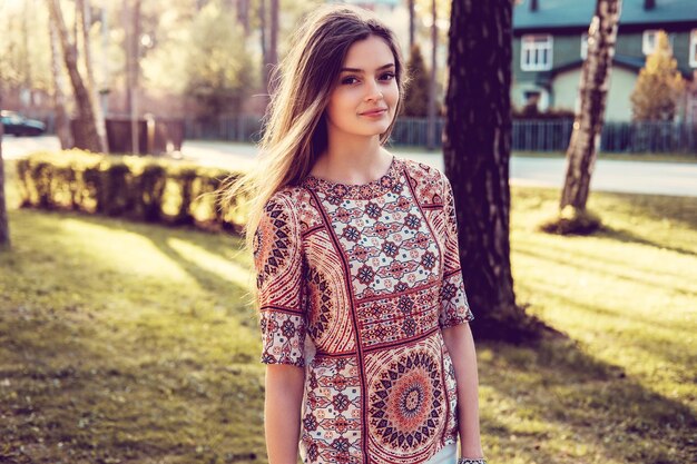 Attractive young female posing in a summer park.