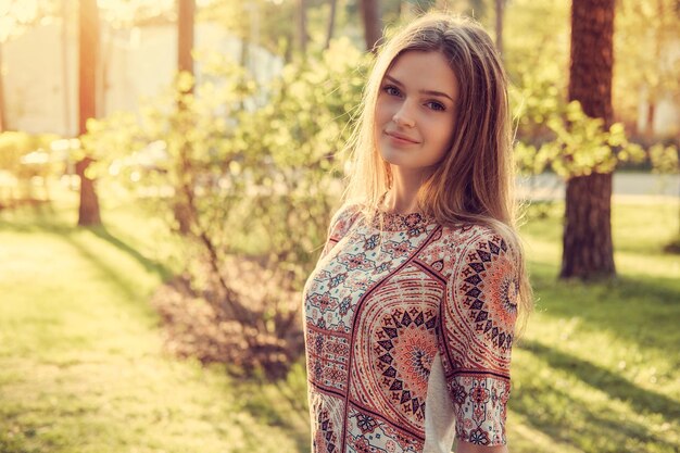 Attractive young female posing in a summer park.