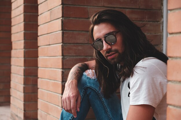 Attractive young man wearing sunglasses