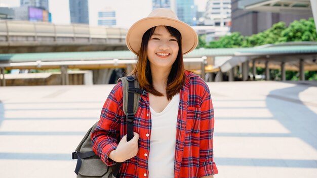 Attractive young smiling Asian woman outdoors portrait in the city