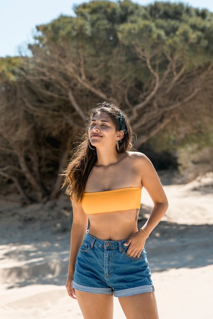 Attractive young woman enjoying sunlight and nature