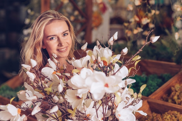 An attractive young woman holding white flower bouquet