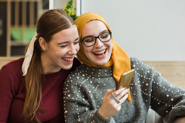 Attractive young women laughing together