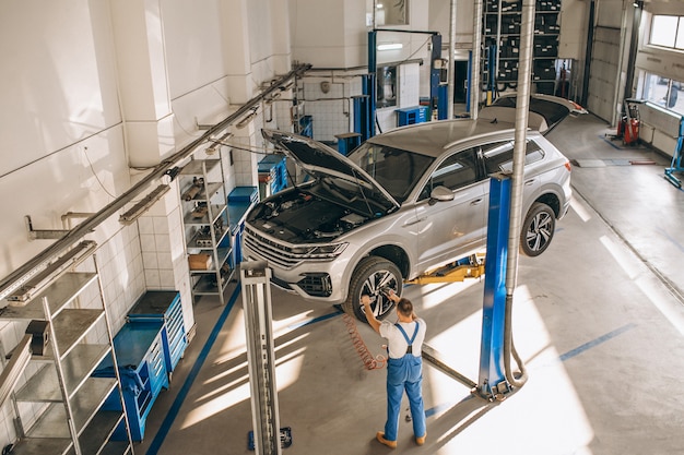 Auto mechanic checking car