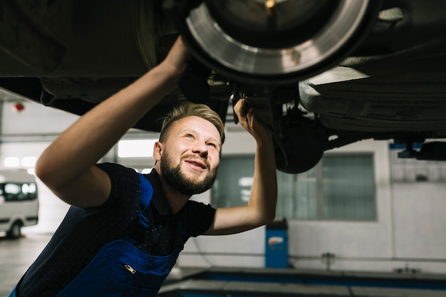 Auto mechanic looking car's bilge