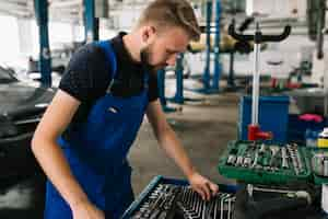 Free photo auto mechanic looking selection of spanners