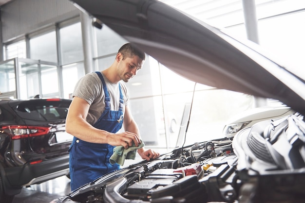 Auto mechanic working in garage. Repair service.