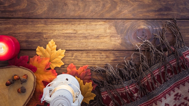 Free photo autumn blanket and lantern composition