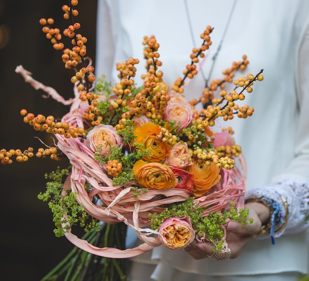 Autumn bouquet with yellow roses and berries