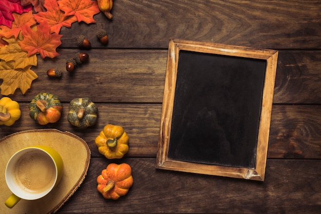 Free photo autumn composition with chalkboard frame and coffee