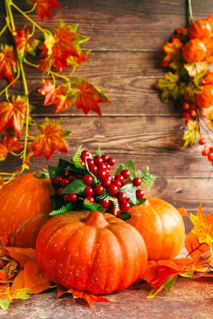 Free photo autumn composition with pumpkins on table