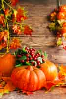 Free photo autumn composition with pumpkins on table