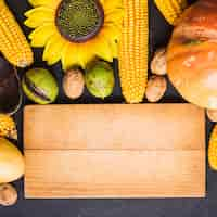 Free photo autumn food concept with wooden board and sunflower