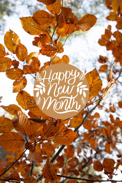 Free photo autumn leaves arrangement with happy new month lettering